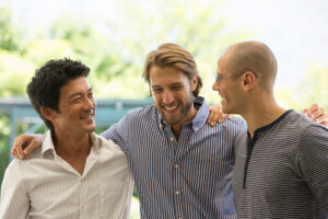 Three men giving each other side hugs after medical detox in Florida.