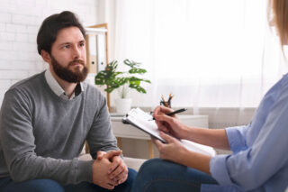 man speaking with therapist about anxiety disorder