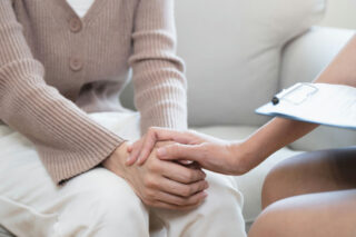 Therapist reassuring individual in DBT for addiction treatment.