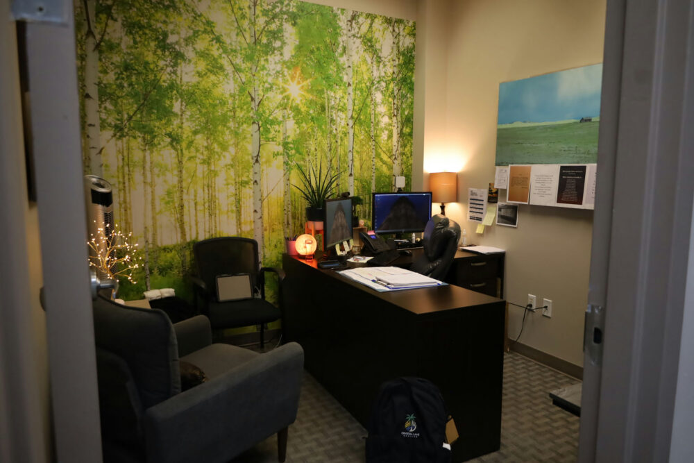 Therapy office with a calming forest mural used in PTSD and addiction treatment